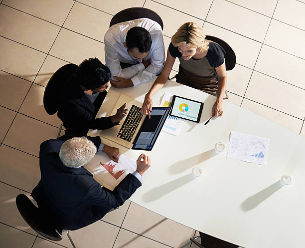 high angle shot of colleagues discussing a financial report